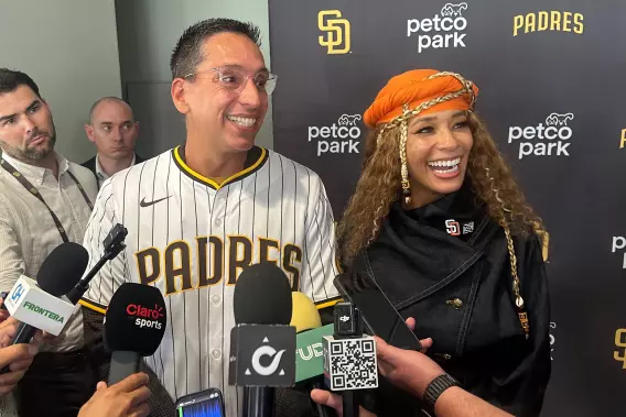 New San Diego Padres owners Kwanza Jones, right, and José E. Feliciano speak to reporters.